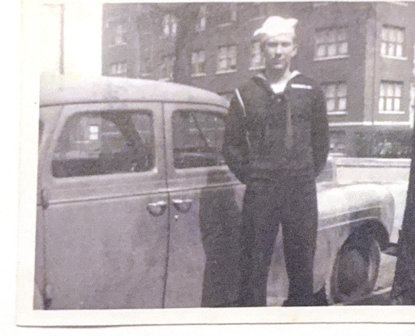 George Milton Krotzer in Navy uniform, beside a car